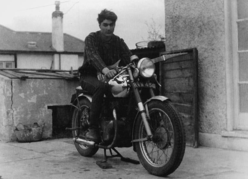 Roy astride the 500cc BSA motorbike that he restored from scratch in 1963, with his homemade guitar slung across the tank.