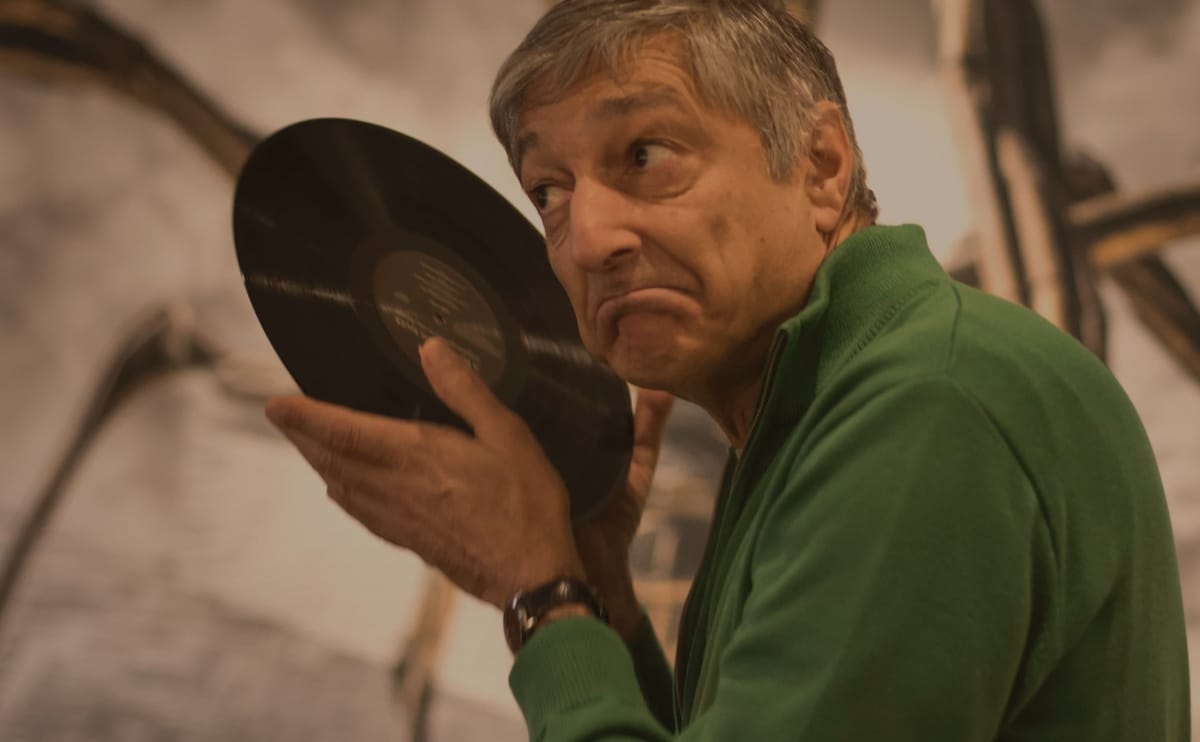 Roy Gandy listening (quite literally) to a record.